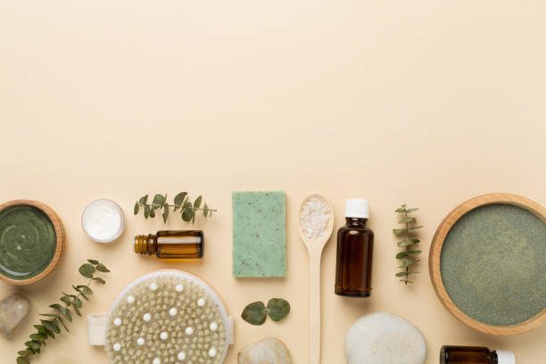 Home composition with cosmetic clay and spa products on color background, top view
