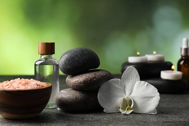 Home composition with spa stones on grey table, closeup